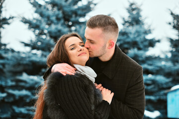 Fototapeta premium Winter love story. smile, hugs and kiss of a couple in love. romance and love
