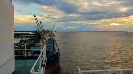 View of bulk carrier vessel n Brazilian port during sunset