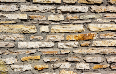 Horizontally aligned limestone wall stone blocks. Colorful texture of the limestone walls. Limestone wall texture, built structure, building exterior, construction industry
