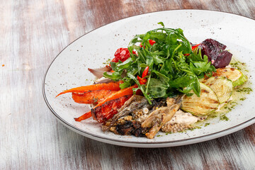 Grilled vegetables on a hummus cushion. Eggplant, pepper, tomato, zucchini, garlic.