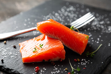 Pieces of smoked salmon on a black plate