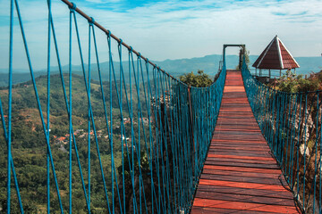 Hanging bridge that connecting two hills of rock at Stone Garden Padalarang, Bandung. Suspension bridge, rope bridge