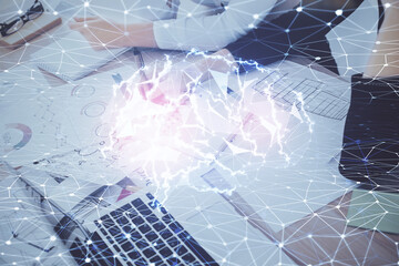 Double exposure of woman's writing hand on background with brain hud. Concept of learning.