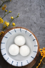 Top view of big tangyuan yuanxiao in a bowl on gray background for lunar new year food.