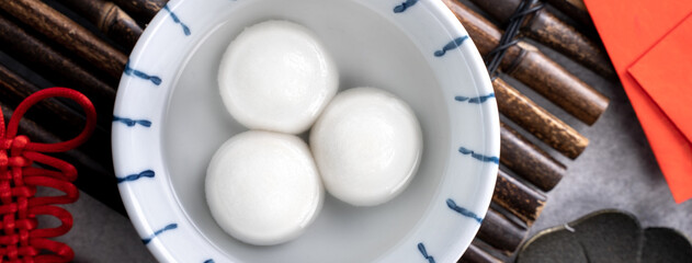 Top view of big tangyuan yuanxiao in a bowl on gray background for lunar new year food.