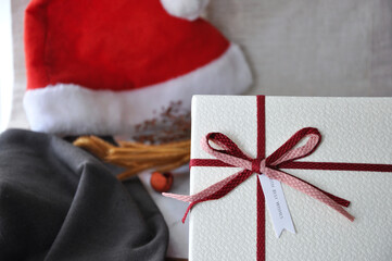 Close up White Gift Box and Santa Hat on Background with Copy Space