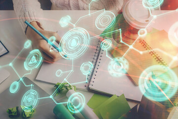 Social network theme hologram over woman's hands writing background. Concept of international people connect. Double exposure