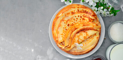 Thin homemade pancakes with berries, pancakes with cherries. Light concrete background. Top view. Tasty sweet breakfast. Traditional English and French crepes. Ingredients. Copyspace