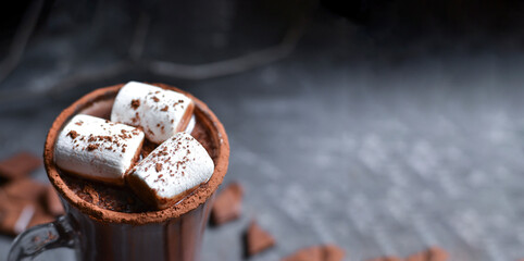 Hot chocolate and marshmallows. Hot Cocoa in a white cup. Dark background. Autumn drink concept. Copy space. Top view