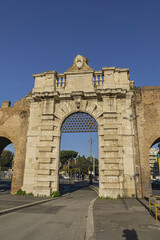 Fototapeta na wymiar Aurelian Wall and Porta San Giovanni (San Giovanni gate, 1574) in city Rome. Italy.