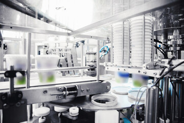 Automated filling of yoghurt into packages. Food production, dairy plant
