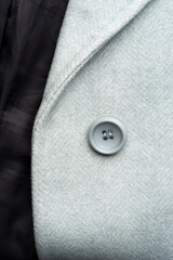 Detail of light blue female coat. Concept of warm everyday things.
