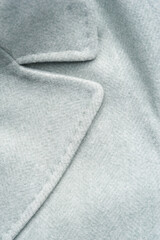 Detail of light blue female coat. Concept of warm everyday things.