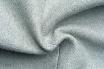 Close-up fragment of warm woolen fabric. Concept of warm everyday things.