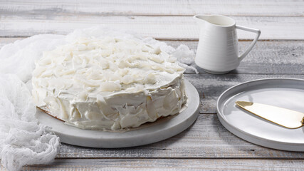 homemade coconut white cake on marble Board on white background, wedding cake