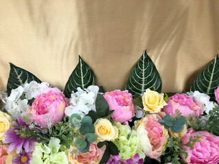 Background of bright colorful artificial flowers. Close up.