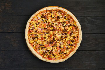 Top view of pizza with minced meat, tomato, onion and cheddar