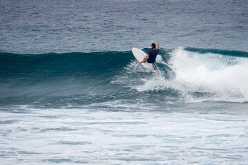 Surfer on perfect blue aquamarine wave, empty line up, perfect for surfing, clean water, Indian Ocean