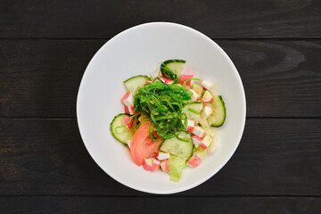Salad with crab meat, seaweed, tomato, cucumber and sesame