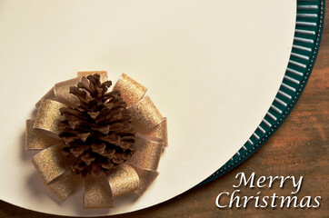 christmas pine cone with bow written "merry christmas"