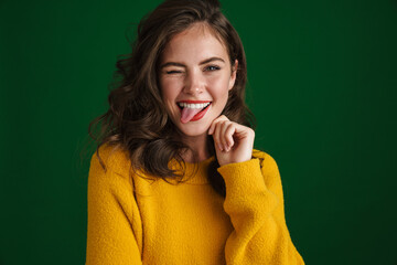 Beautiful happy girl winking and showing her tongue