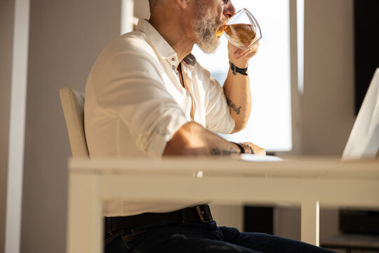 Entrepreneur tilting a teacup to his mouth