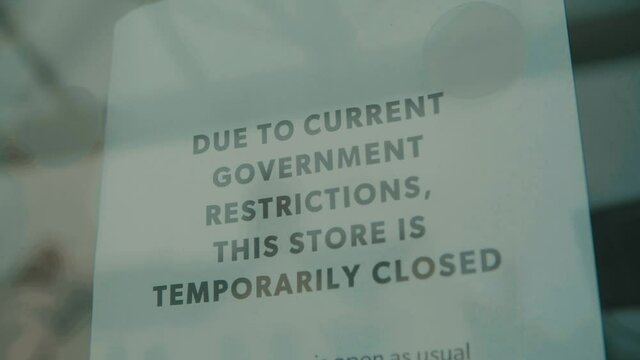 Slow motion shot of independent shop closed until further notice due to the COVID 19 coronavirus pandemic, bars, cafes, restaurants, clubs all shut cause of this international crisis lockdown 2.0 