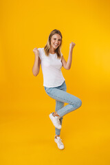 Happy beautiful girl smiling while making winner gesture