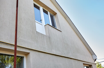 Facade of a European suburban building. Wall of house against a blue sky