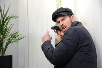 Obnoxious nosy sneeky neighbour peeking through the window