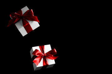 Present online. White gifts with red bow falling on black background for Black Friday banner. Flying backdrop with space for text.