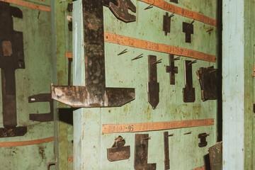 Metal attachments for metal processing machine, abandoned old industrial plant.