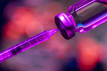 Bottle of coronavirus vaccine and syringe over Europe continent map of infections. Close up....