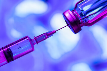 Covid-19 Corona Virus 2019-ncov vaccine vials medicine drug bottles syringe injection on blue light background. Vaccination, immunization, treatment to cure Covid 19 Corona Virus infection Concept