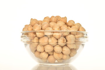 Uncooked hummus grains, close-up, isolated on white.