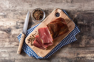 Dried and smoked meat on wooden table. Top view