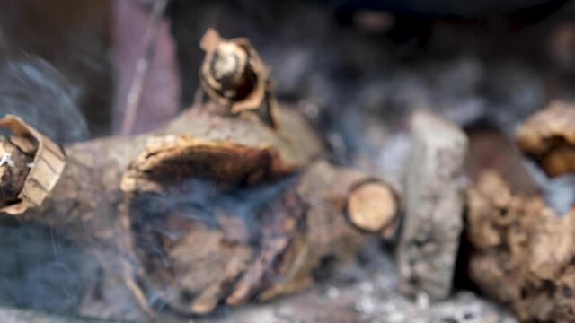 The logs were burned with ashes and white smoke emitted.