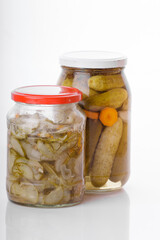 Glass jars of pickled homemade cucumber. Organic vegetables  isolated on white background. 