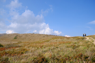 Tourists treking to Polonina Wetlinska. Bieszczady Mountains landscape.