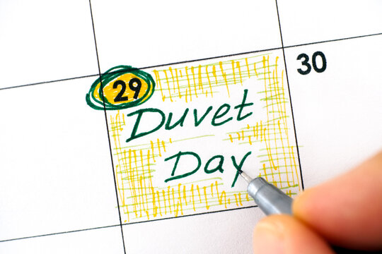 Woman Hand With Pen Writing Reminder Duvet Day In Calendar.