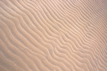 Fototapeta na wymiar Sandy pattern background. Natural dune waves.