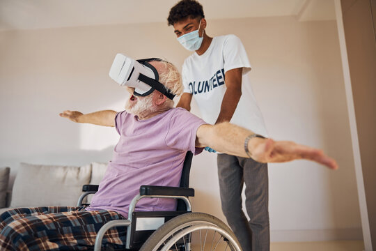 Pleased senior Caucasian man enjoying virtual reality