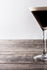 Martini espresso cocktail in glass on wooden table. Close up