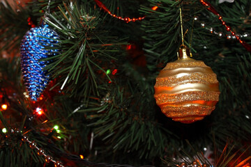 Christmas balls on a branch of a Christmas tree close-up. Macro photography of Christmas toys. Christmas background with Christmas toys.