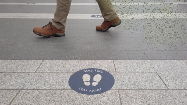 Walking Man Shedding Virus Particles.

Lower Legs Of A Man Walking By A Distancing Sign And Shedding Covid Particles.