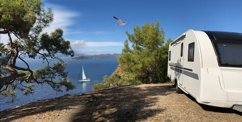 Caravan or towed trailer on seaside background scene.
