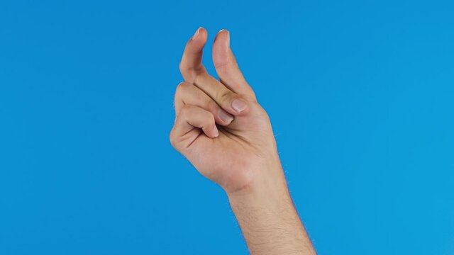 Male hand with snapping fingers on blue screen background. Slow motion video.