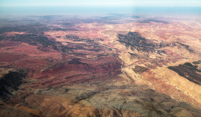 Flying above colourful and dry Moroccan mountainous landscape. 
