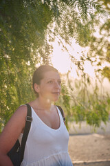 photograph of a woman posing in the street in the sun