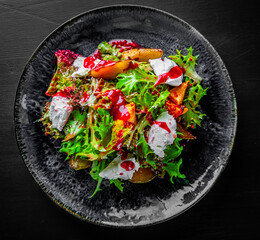 Plate of fresh salad with grilled chicken, pear, cream cheese in plate